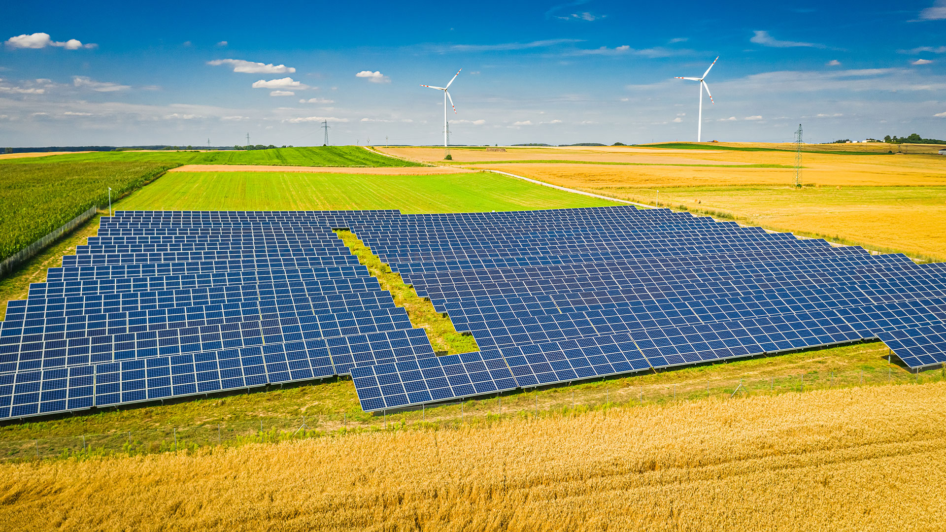 solar-panels-and-wind-turbines-on-field-aerial-vi-2022-04-02-10-14-42-utc